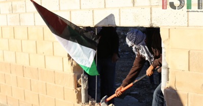 Palestinian Activists Destroy Section of Apartheid Wall